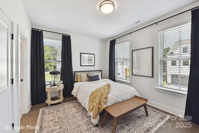 a bedroom with a bed and glass window