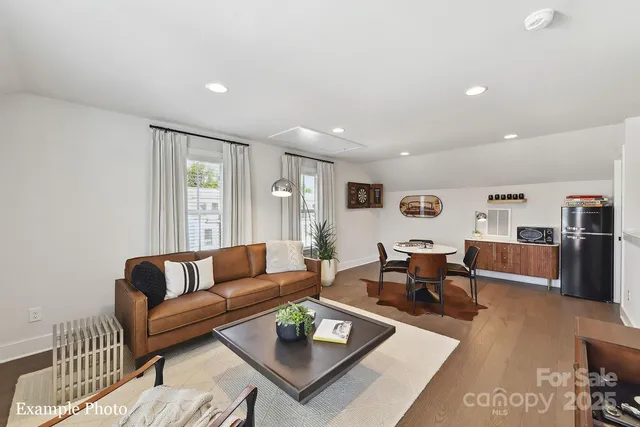 a living room with furniture wooden floor and a table