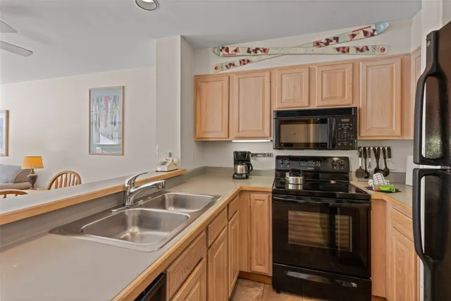 a kitchen with a sink stove and microwave