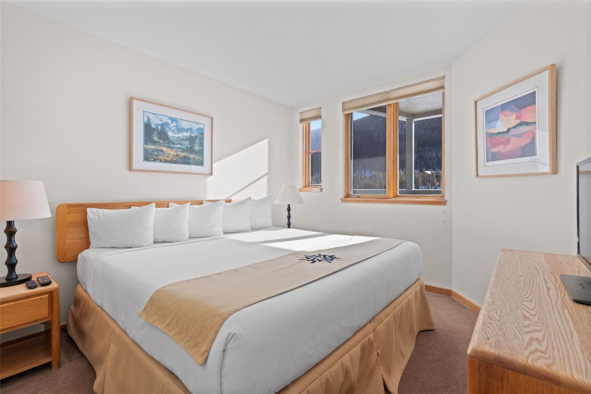 22174 Highway 6, Unit 1531 Keystone, CO 80435 - Photo 15 of 27 a bedroom with a bed and a painting on the wall