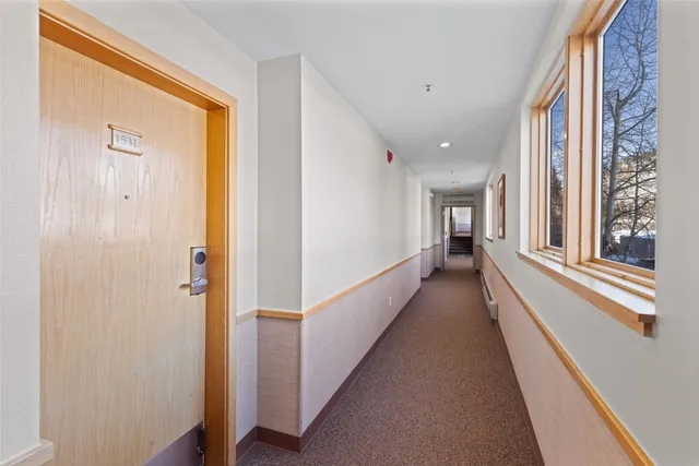 a view of a hallway with windows