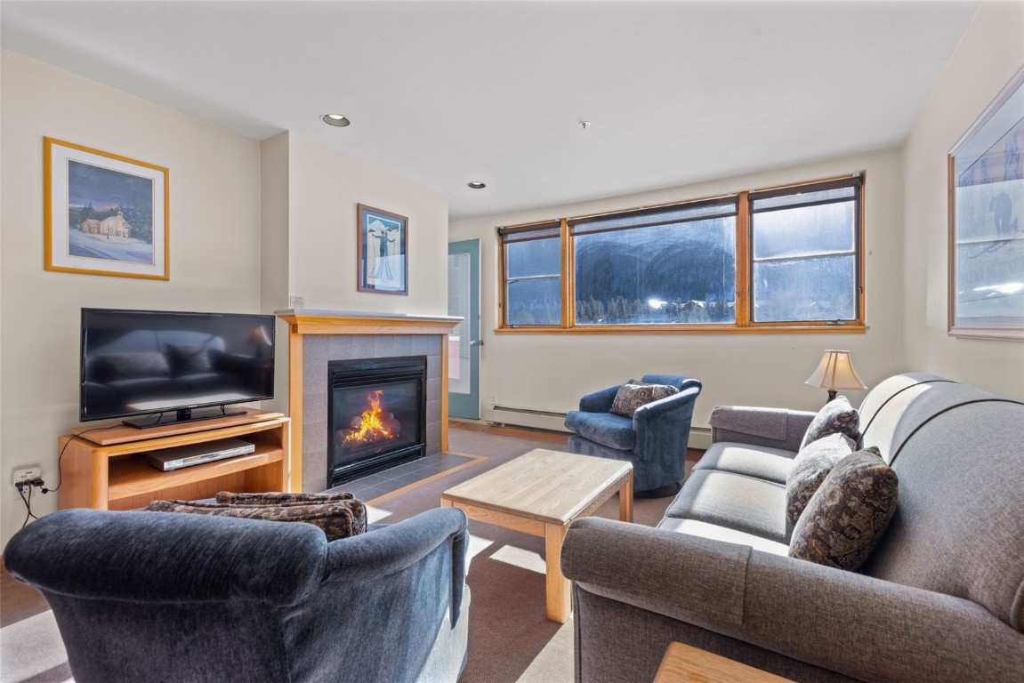 22174 Highway 6, Unit 1531 Keystone, CO 80435 - Photo 3 of 27 a living room with furniture and a fireplace