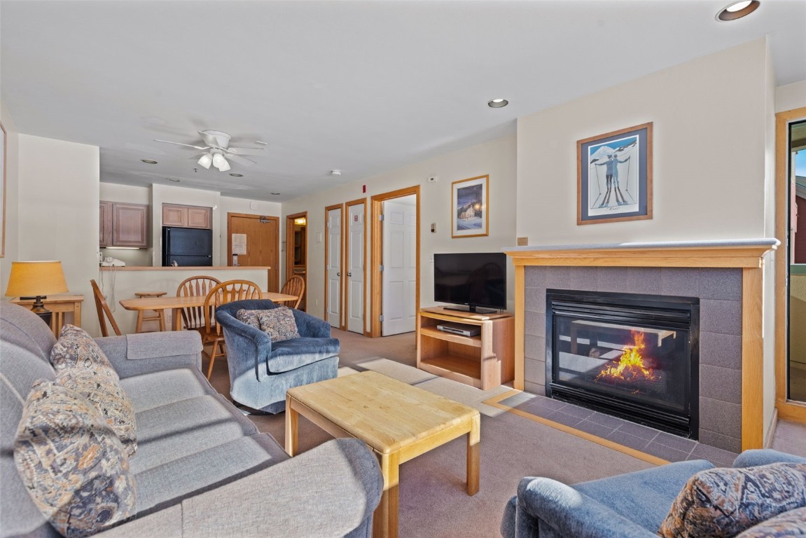 22174 Highway 6, Unit 1531 Keystone, CO 80435 - Photo 4 of 27 a living room with furniture a fireplace and a flat screen tv