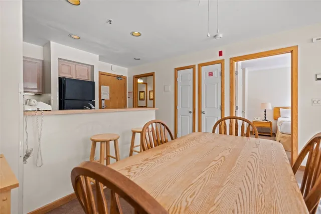 a bedroom with a bed a dresser and a flat screen tv