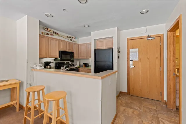 a kitchen with stainless steel appliances a refrigerator stove microwave and sink