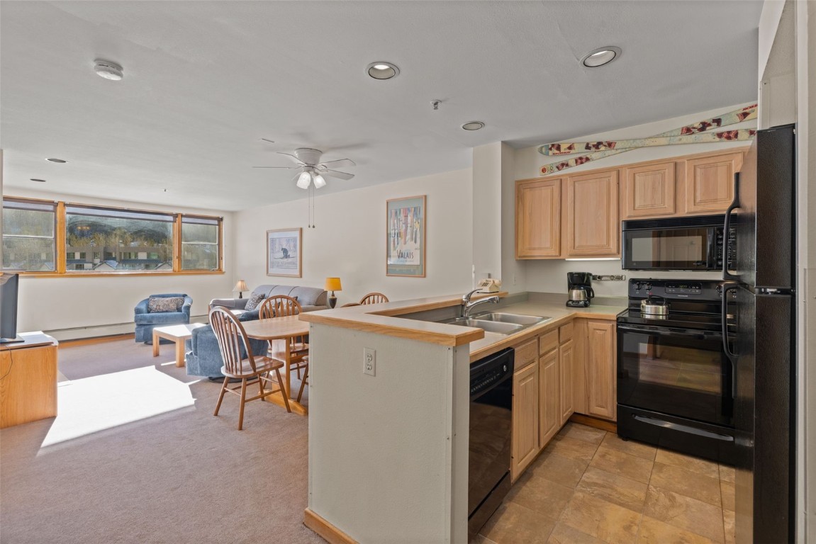 22174 Highway 6, Unit 1531 Keystone, CO 80435 - Photo 10 of 27 a kitchen with a sink stove and chairs