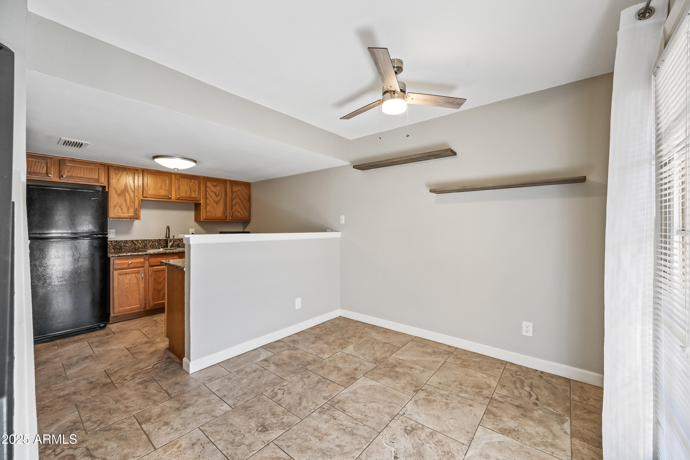 3511 East Baseline Road, Unit 1147 Phoenix, AZ 85042 - Photo 8 of 37 a view of a kitchen with a sink and refrigerator