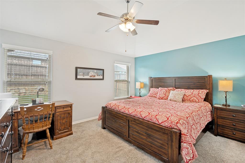 3905 Bridle Path Lane Sanger, TX 76266 - Photo 15 of 26 a bedroom with a bed and a chandelier