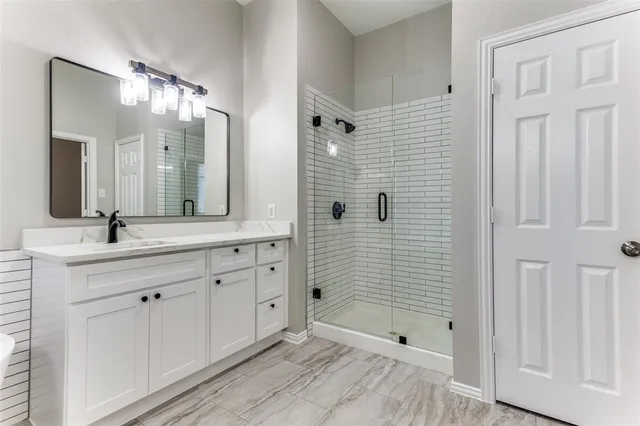 a bathroom with a double vanity sink and mirror