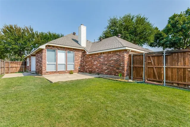 a front view of a house with yard and green space