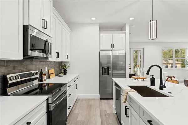 a kitchen with a sink a stove and refrigerator