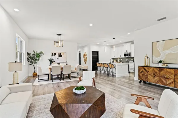 a living room with furniture and wooden floor
