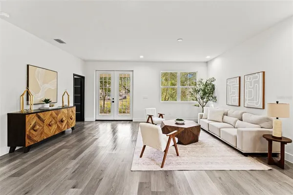a living room with furniture and wooden floor