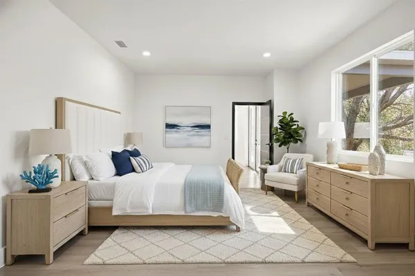a bedroom with a large bed and a couch