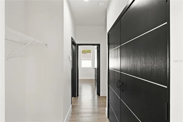 a view of hallway with wooden floor
