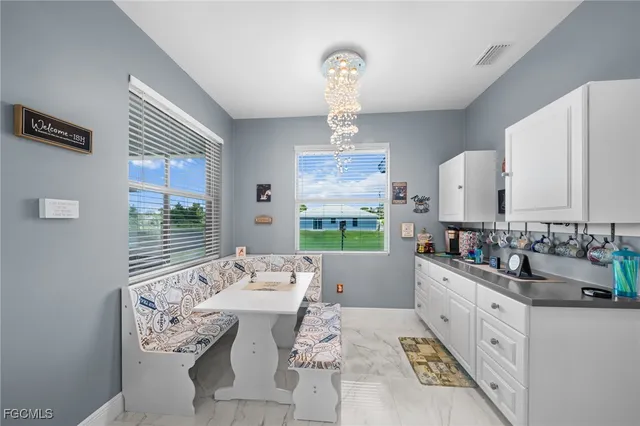 a large white kitchen with a large window