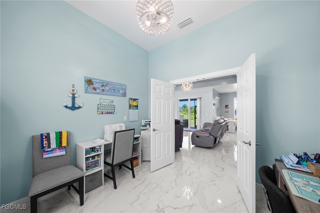 2906 9th Street Southwest Lehigh Acres, FL 33976 - Photo 13 of 30 a view of a livingroom with workspace and a couch