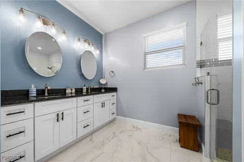 a bathroom with double sink and a mirror