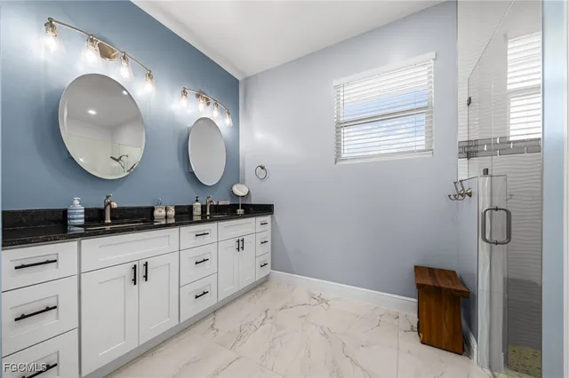 a bathroom with double sink and a mirror