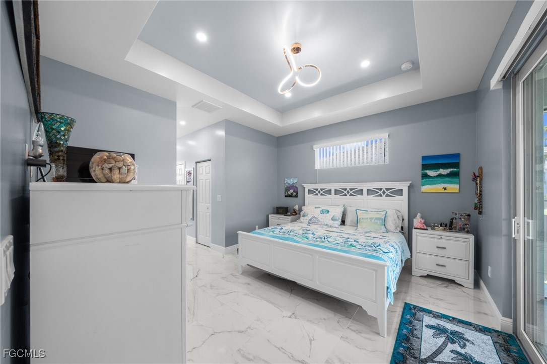 2906 9th Street Southwest Lehigh Acres, FL 33976 - Photo 18 of 30 a bedroom with a bed and a refrigerator