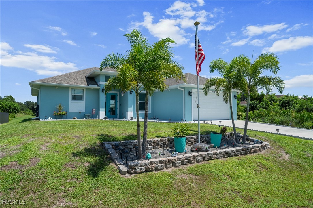 2906 9th Street Southwest Lehigh Acres, FL 33976 - Photo 24 of 30 a house view with a garden space