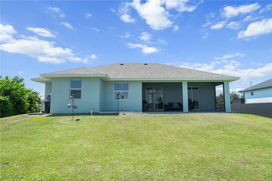 2906 9th Street Southwest Lehigh Acres, FL 33976 - Photo 26 of 30 a view of a house with a garden and yard