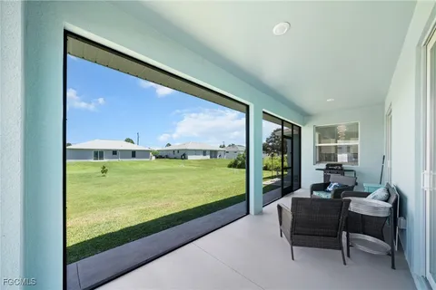 a balcony with furniture and a yard