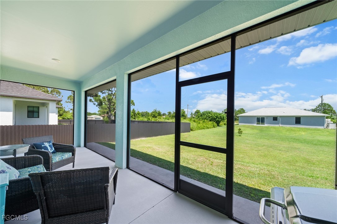 2906 9th Street Southwest Lehigh Acres, FL 33976 - Photo 28 of 30 a view of an empty room with large windows
