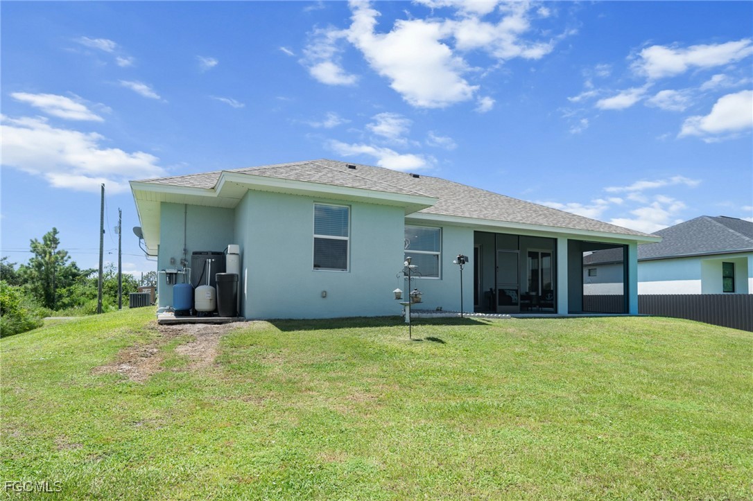 2906 9th Street Southwest Lehigh Acres, FL 33976 - Photo 29 of 30 a view of a house with a yard and garage