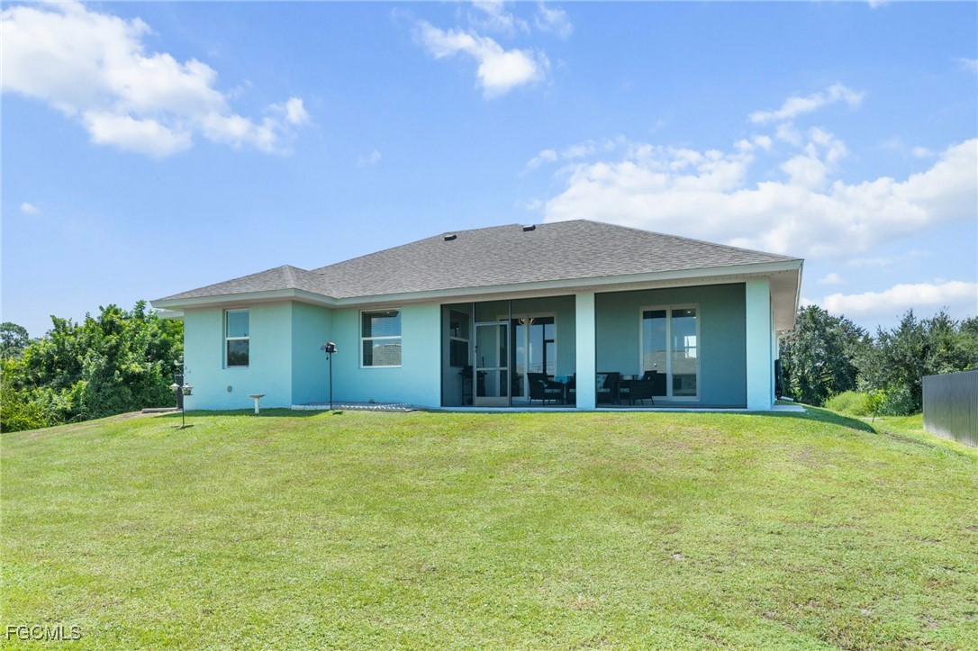 2906 9th Street Southwest Lehigh Acres, FL 33976 - Photo 30 of 30 a view of a house with a yard and large tree