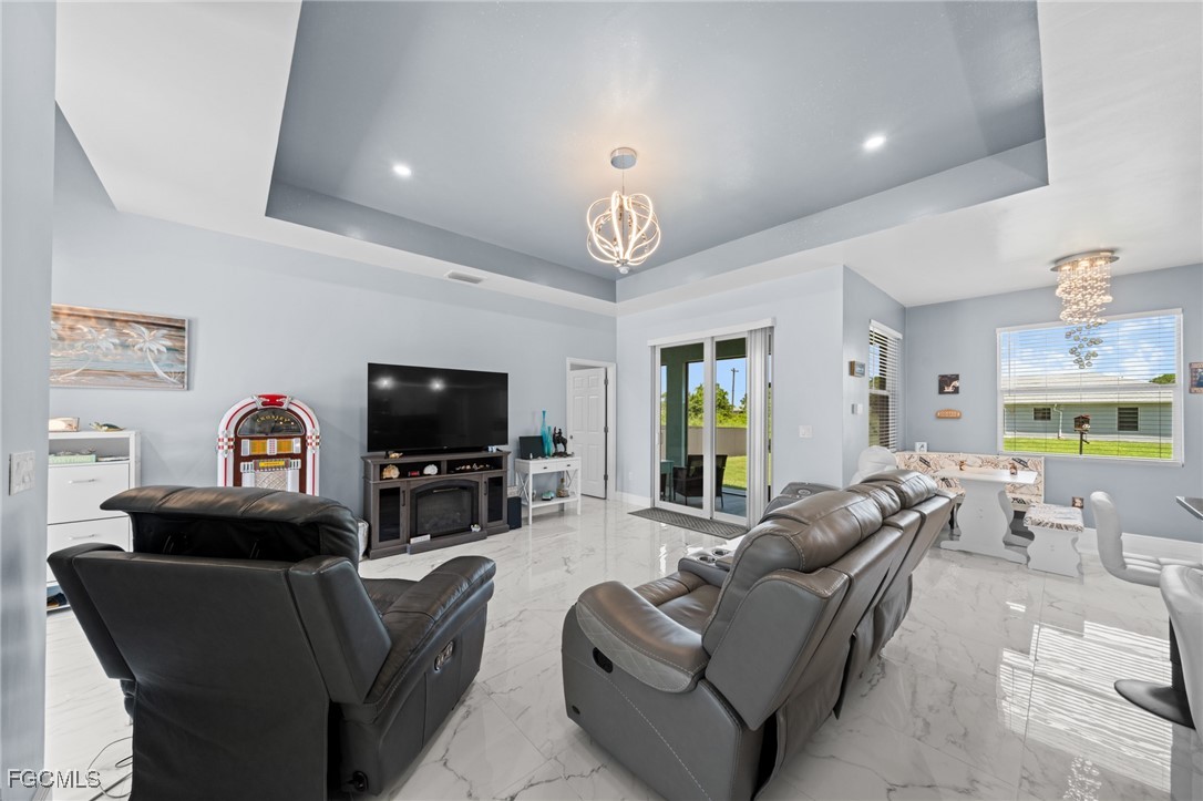 2906 9th Street Southwest Lehigh Acres, FL 33976 - Photo 3 of 30 a living room with furniture and a flat screen tv