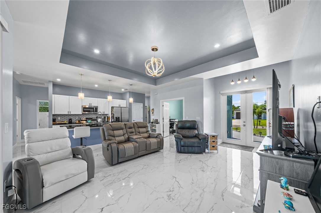 2906 9th Street Southwest Lehigh Acres, FL 33976 - Photo 5 of 30 a living room with fireplace furniture and a flat screen tv