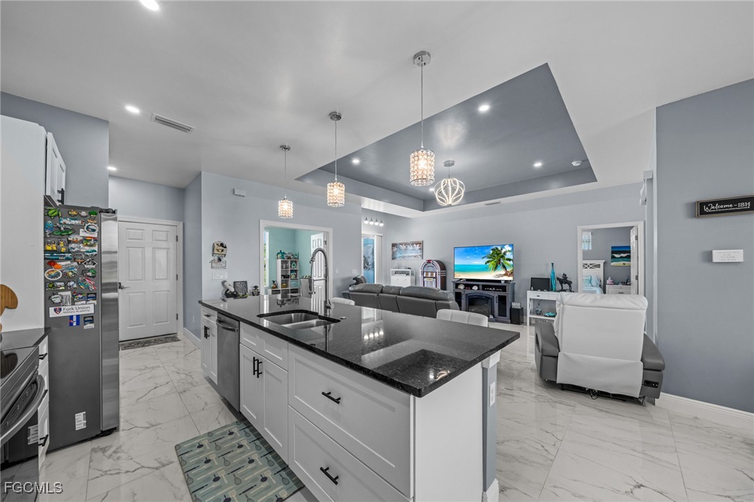 2906 9th Street Southwest Lehigh Acres, FL 33976 - Photo 7 of 30 a large kitchen with a counter space and furniture