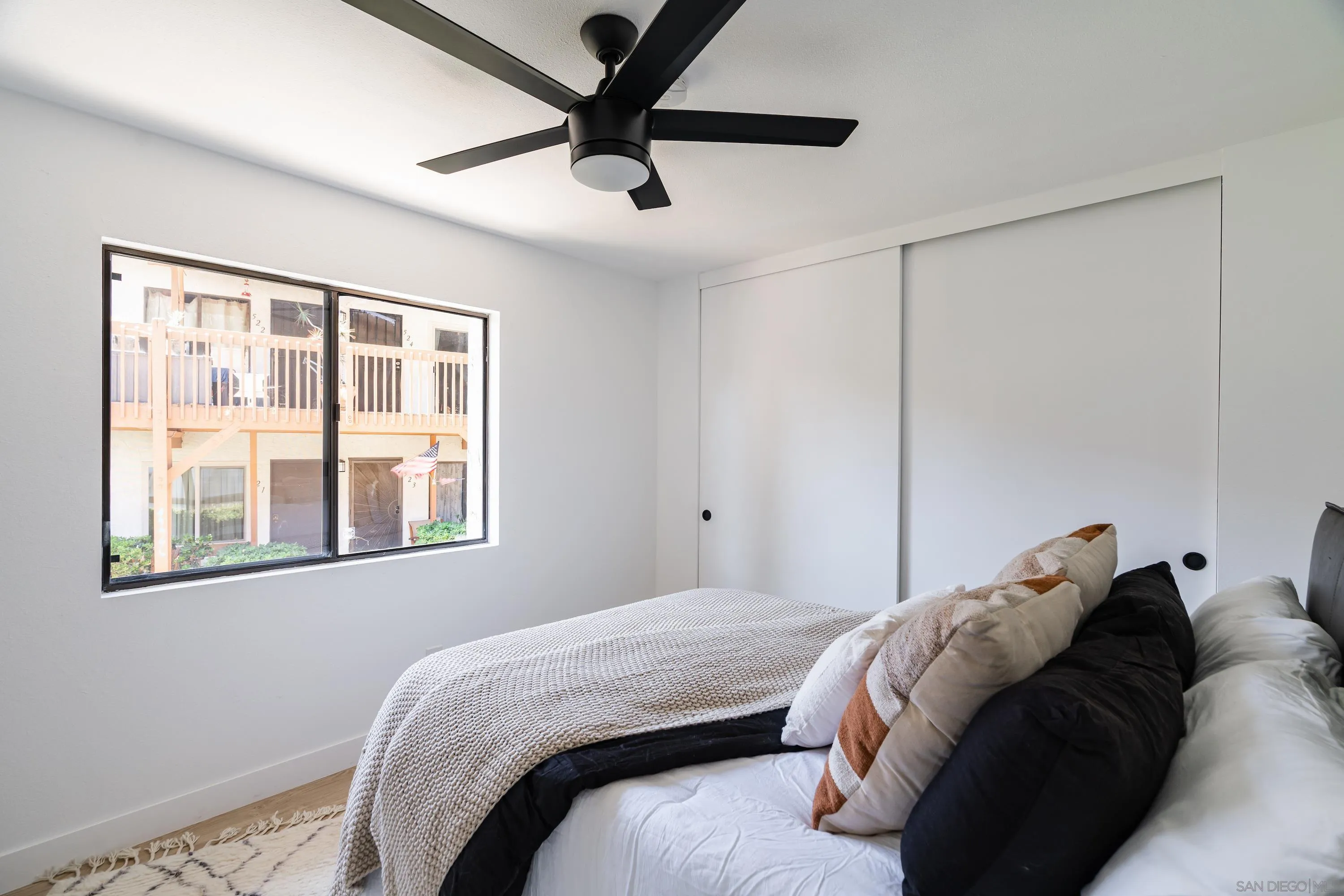 6376 Rancho Mission Road, Unit 402 San Diego, CA 92108 - Photo 13 of 27 a bedroom with a bed and a window