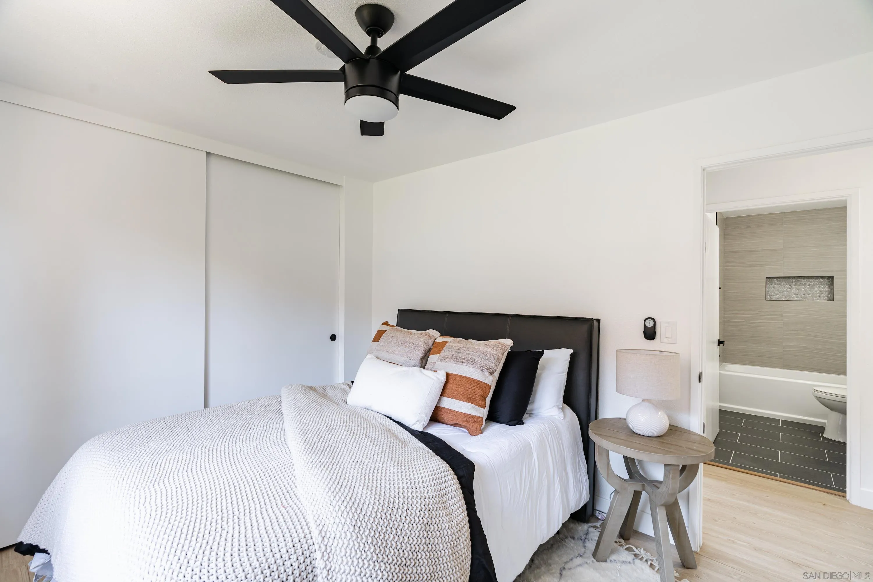 6376 Rancho Mission Road, Unit 402 San Diego, CA 92108 - Photo 14 of 27 a bedroom with a bed and a chandelier