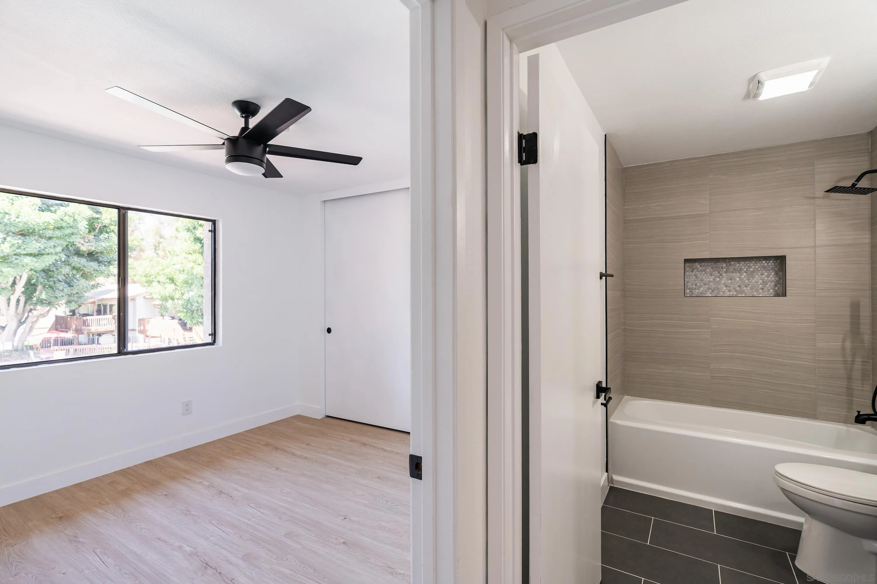 6376 Rancho Mission Road, Unit 402 San Diego, CA 92108 - Photo 17 of 27 a view of a bathroom with a tub toilet and a sink