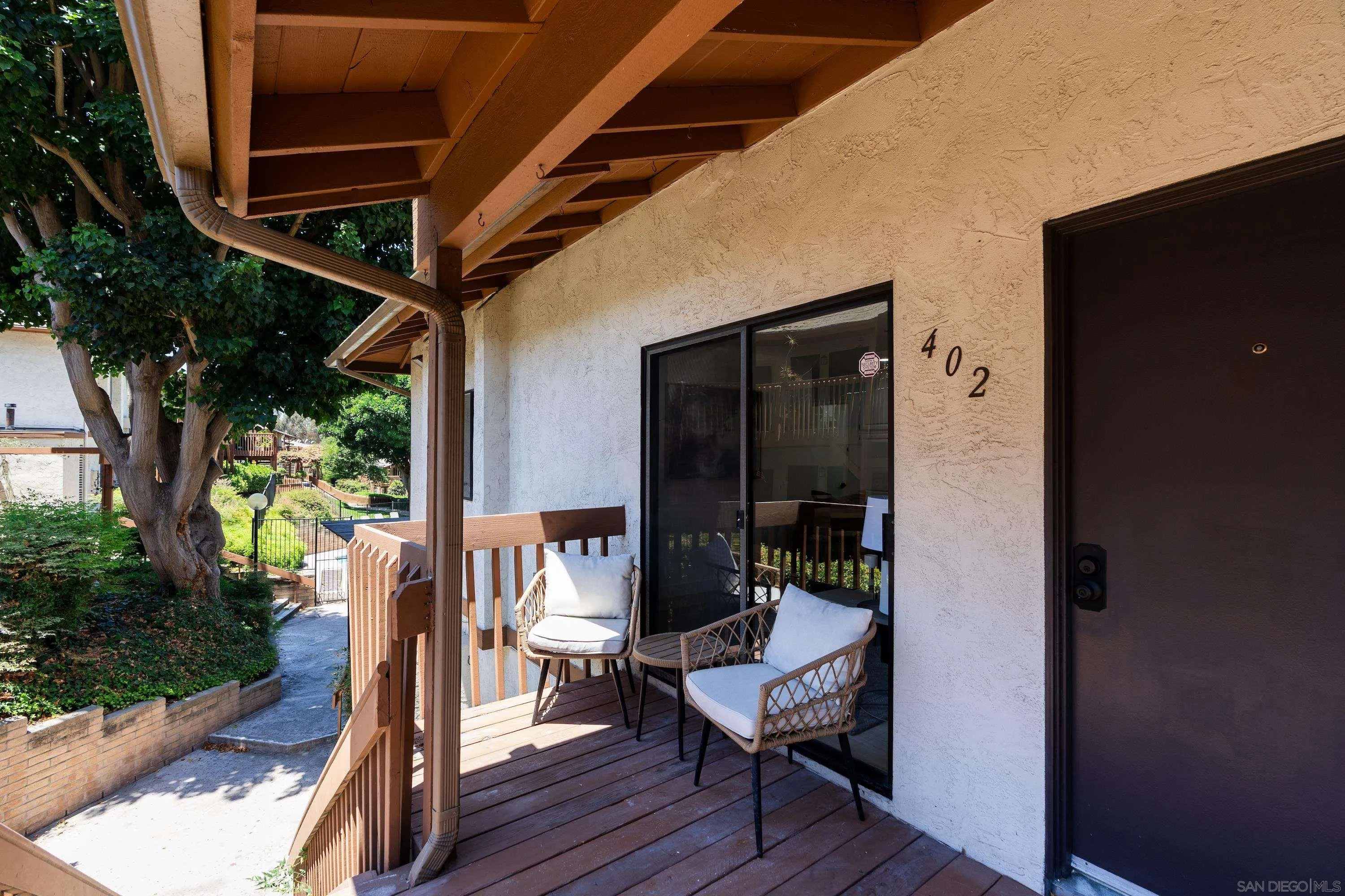 6376 Rancho Mission Road, Unit 402 San Diego, CA 92108 - Photo 21 of 27 a view of balcony with wooden floor and outdoor seating