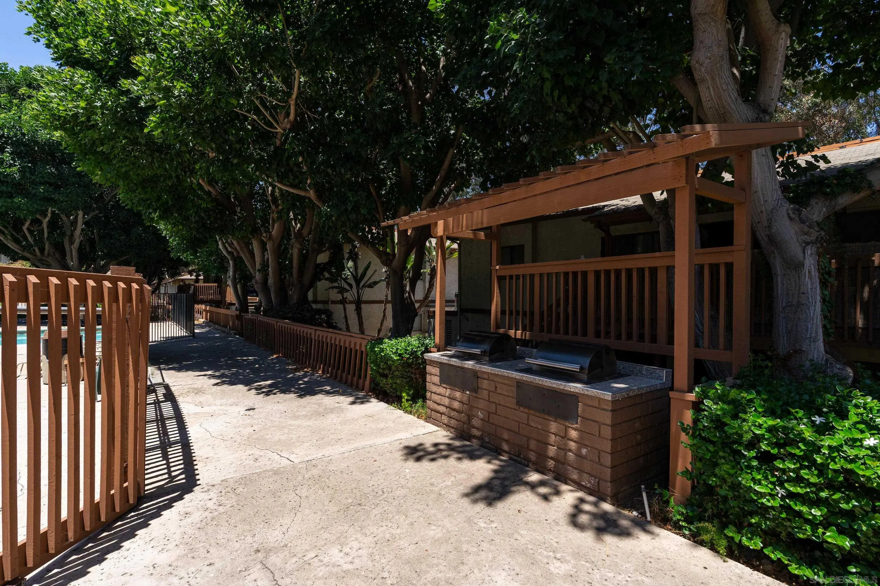 6376 Rancho Mission Road, Unit 402 San Diego, CA 92108 - Photo 24 of 27 a view of backyard with green space and wooden fence