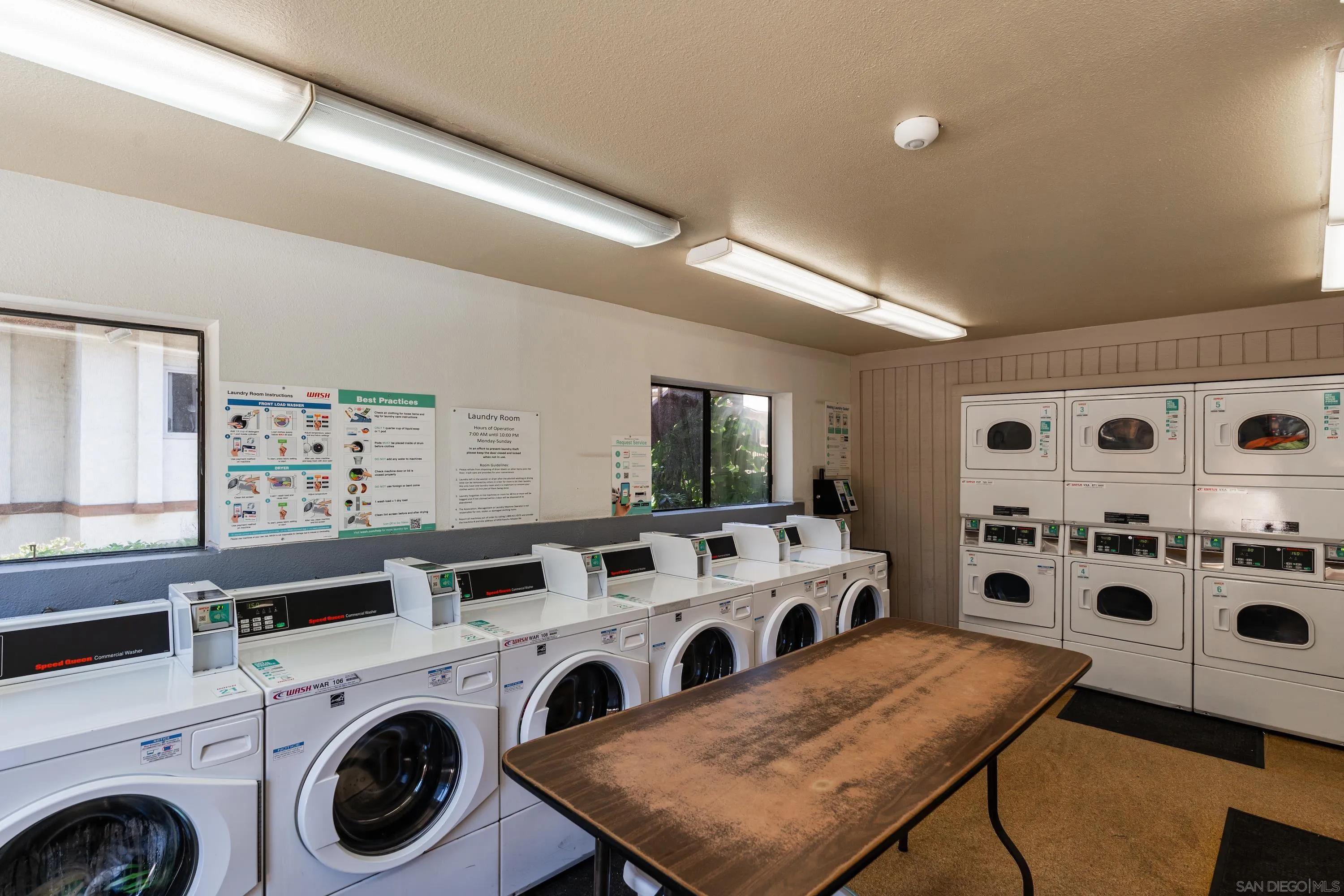 6376 Rancho Mission Road, Unit 402 San Diego, CA 92108 - Photo 25 of 27 a view of washer and dryer with kitchen in the background