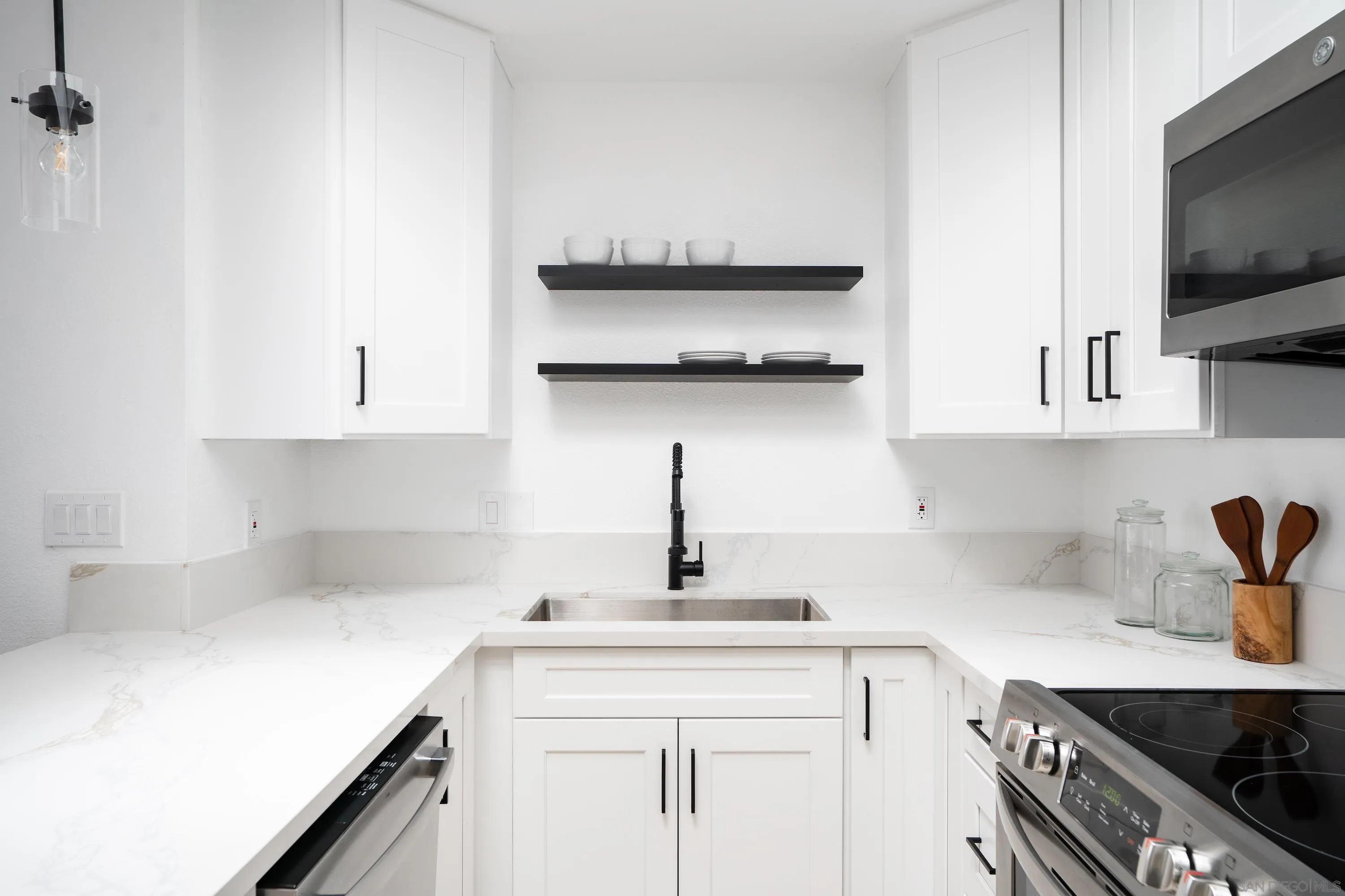 6376 Rancho Mission Road, Unit 402 San Diego, CA 92108 - Photo 6 of 27 a kitchen with stainless steel appliances a sink and cabinets