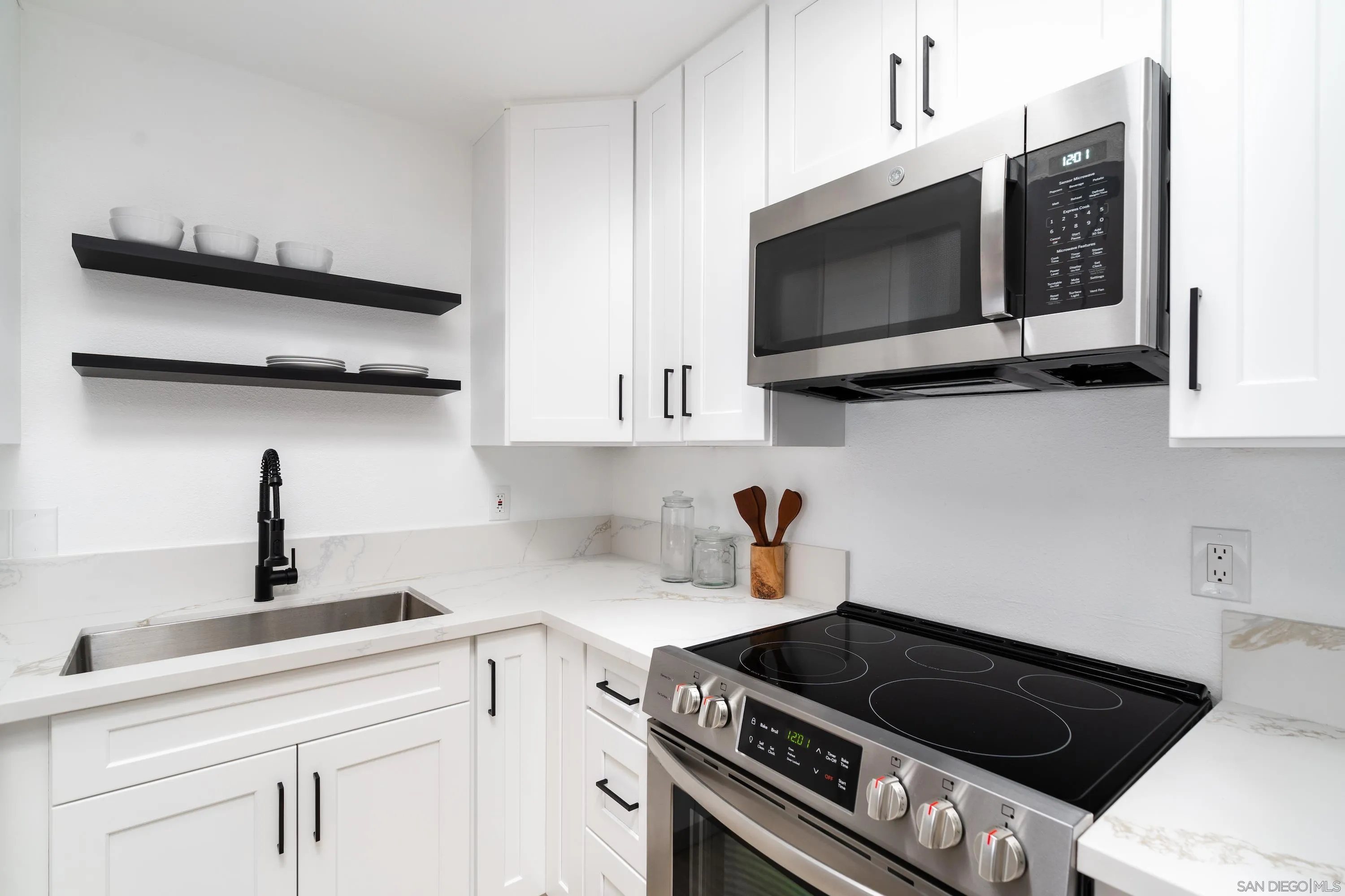 6376 Rancho Mission Road, Unit 402 San Diego, CA 92108 - Photo 7 of 27 a kitchen with stainless steel appliances a sink a stove and cabinets