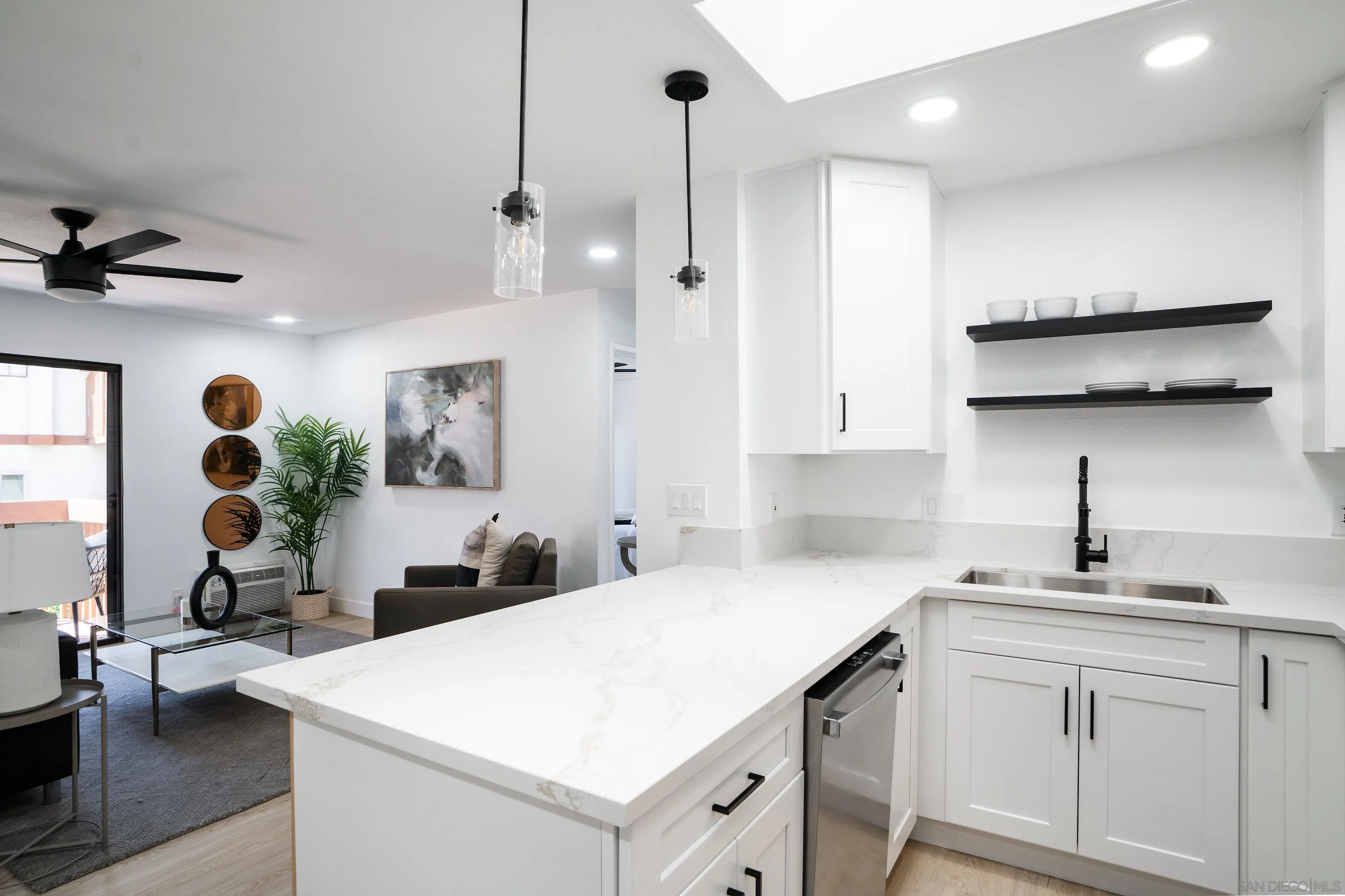 6376 Rancho Mission Road, Unit 402 San Diego, CA 92108 - Photo 8 of 27 a kitchen with white cabinets and sink