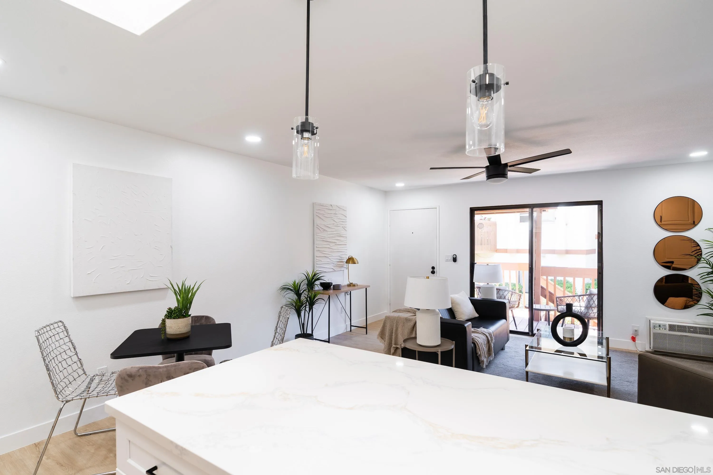 6376 Rancho Mission Road, Unit 402 San Diego, CA 92108 - Photo 9 of 27 a bedroom with a bed and a chandelier