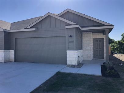 View of front of home with stone siding, board and batten siding, concrete driveway, and an attached garage