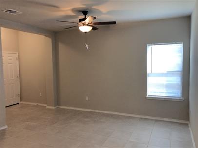 1727 Davidson Ranch Road Georgetown, TX 78626 - Photo 3 of 10 Empty room with light tile patterned floors, visible vents, baseboards, and a ceiling fan