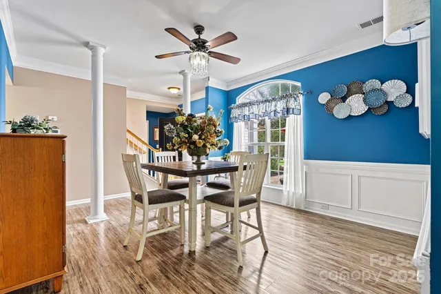 a kitchen with stainless steel appliances granite countertop wooden floors and sink