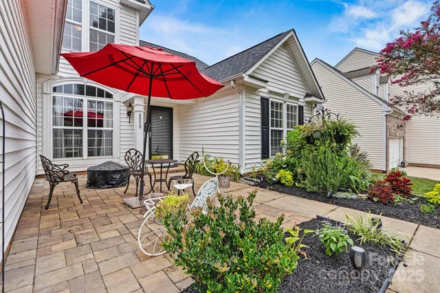 a front view of a house with a garden and plants