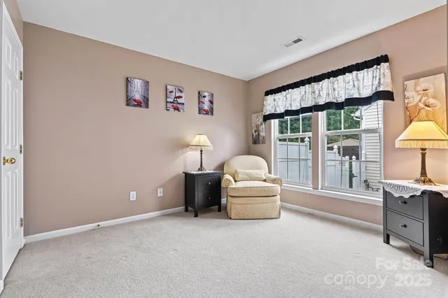 a view of swimming pool with outdoor seating yard and trees in the background