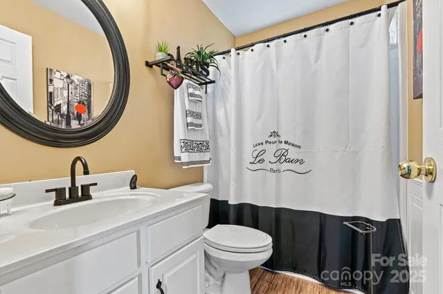 a front view of a house with a yard and potted plants