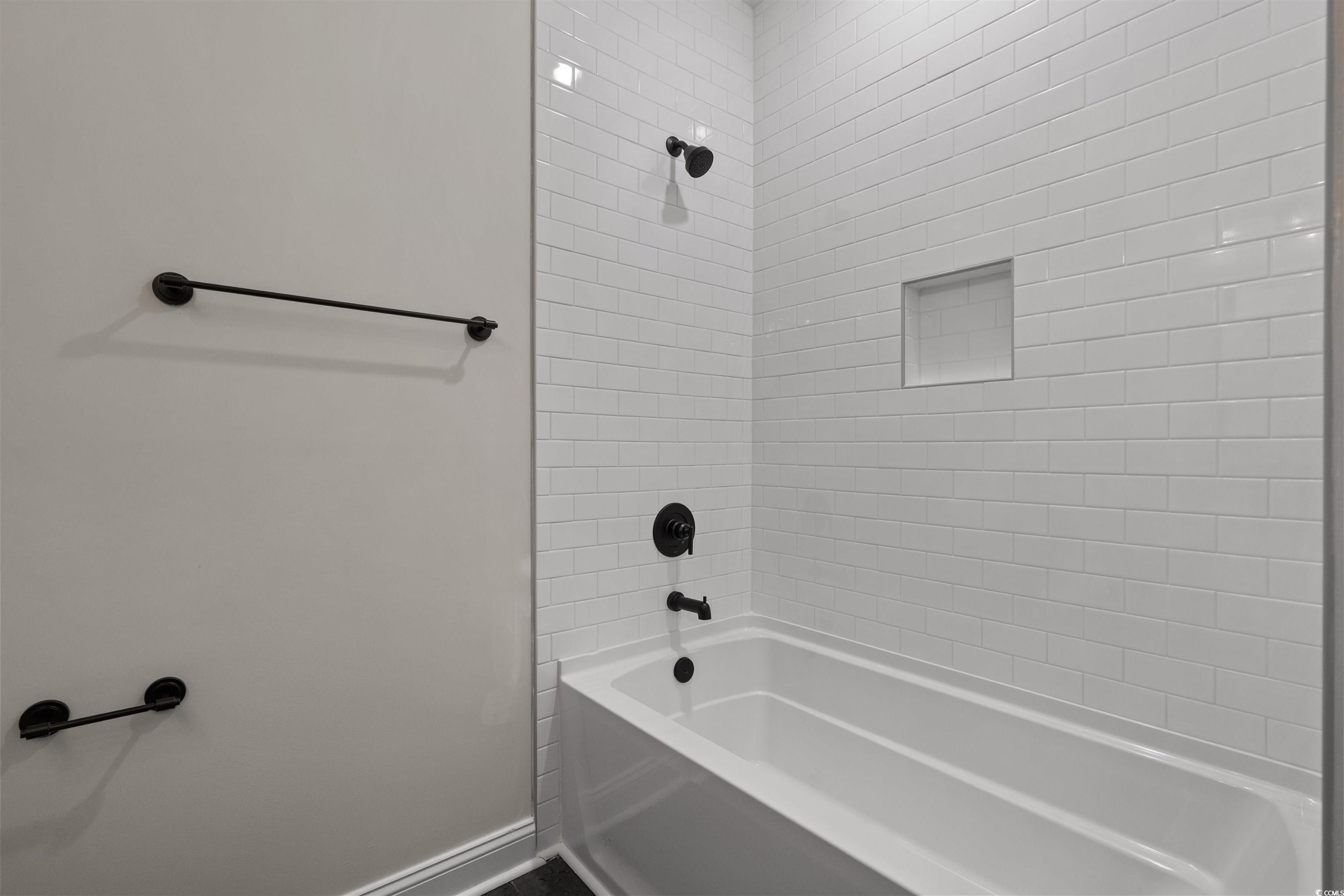 8465 Waltzing Waves Court, Unit 26 Myrtle Beach, SC 29572 - Photo 37 of 40 Full bathroom featuring bathtub / shower combination and baseboards